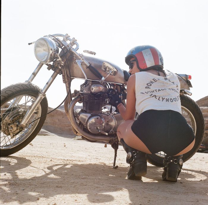 A playful frame from Girls on a motorcycle — online in Delhi